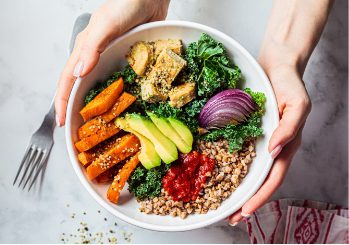 Healthy balanced meal with vegetables, avocado, and grains supporting good oral and overall health.